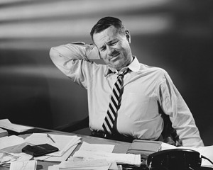 Businessman stretching in an office