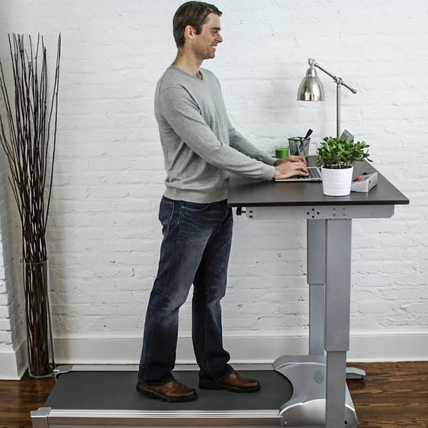 Treadmill desk with a person working at the standing desk treadmill.